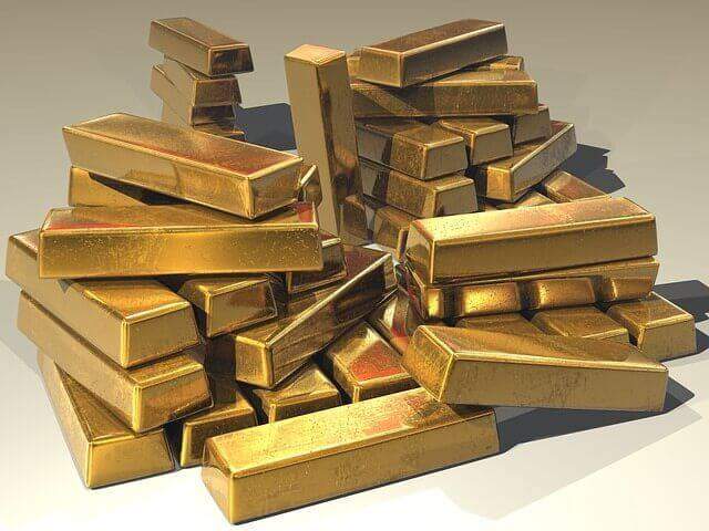 Precious metals for jewelry gold bullion bars stacked in a pile.