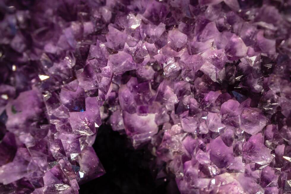 A close-up of an amethyst geode displaying a varied amethyst birthstone color