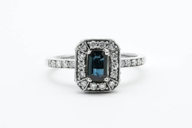 Emerald cut stone with diamond halo setting